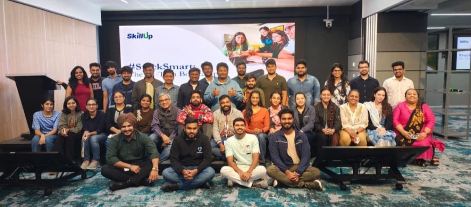 Group photo of participants after an AI bootcamp in a corporate auditorium