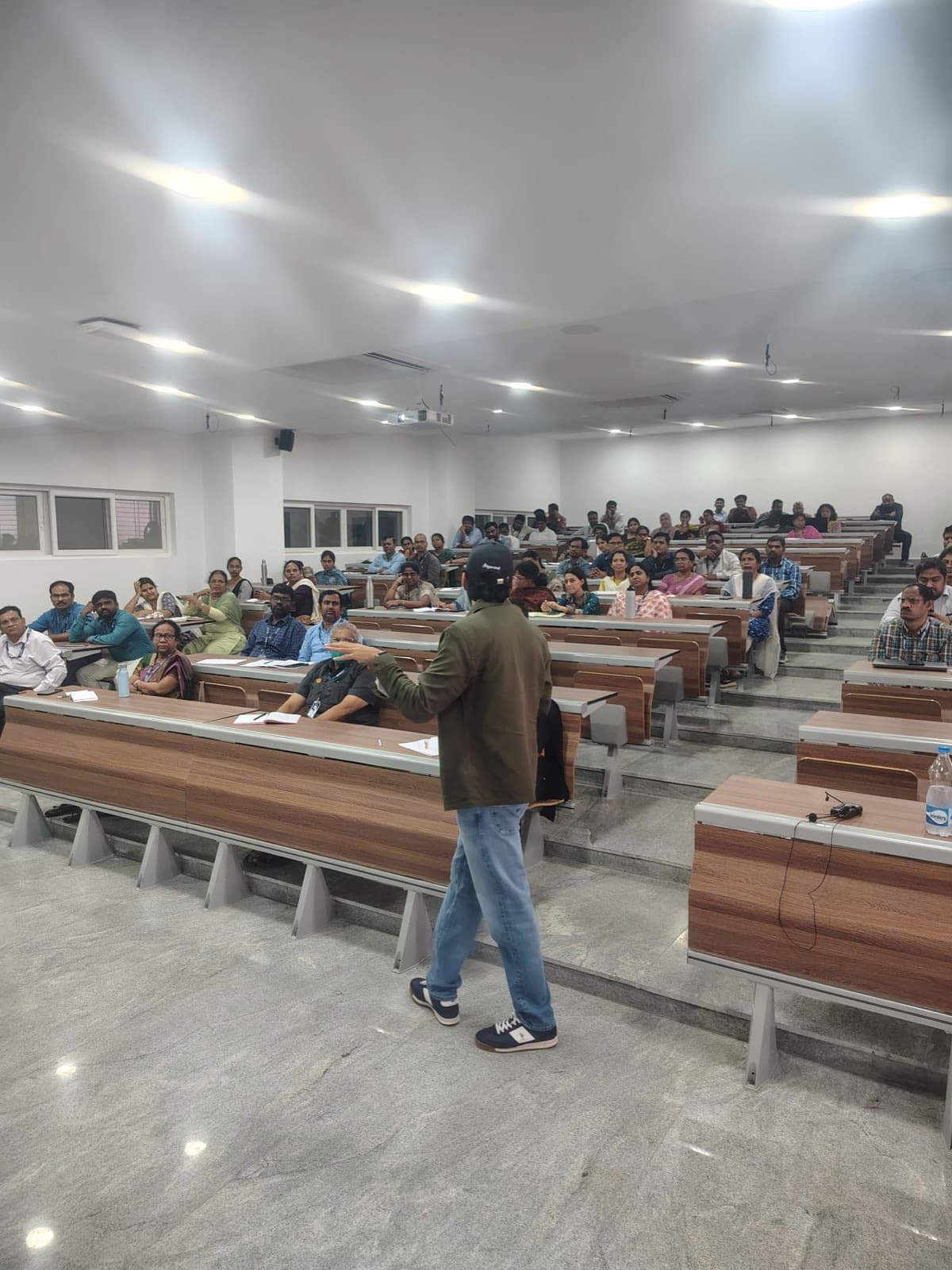 AI session for faculty and professionals in a large tiered auditorium