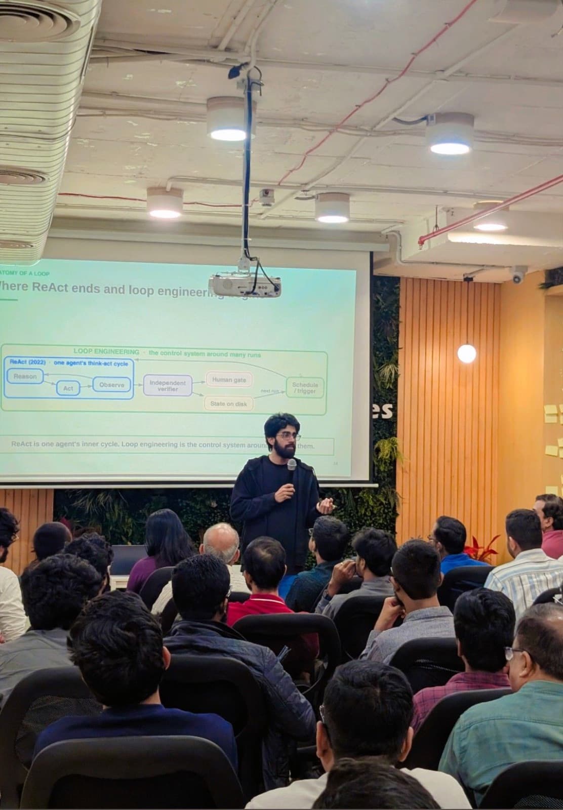 Trainer presenting agent loop engineering beyond ReAct to a full room